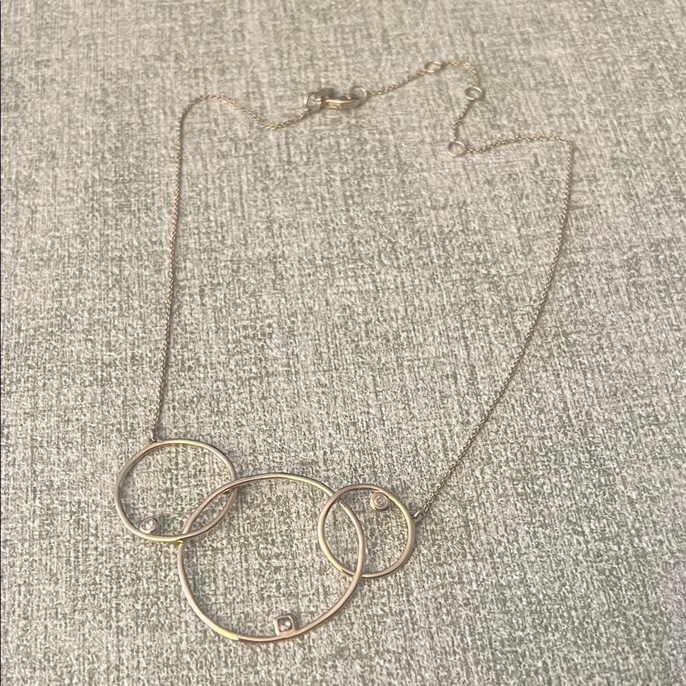 Alexis Bittar Elegant Gold Necklace with Interlocking circles and three stones.